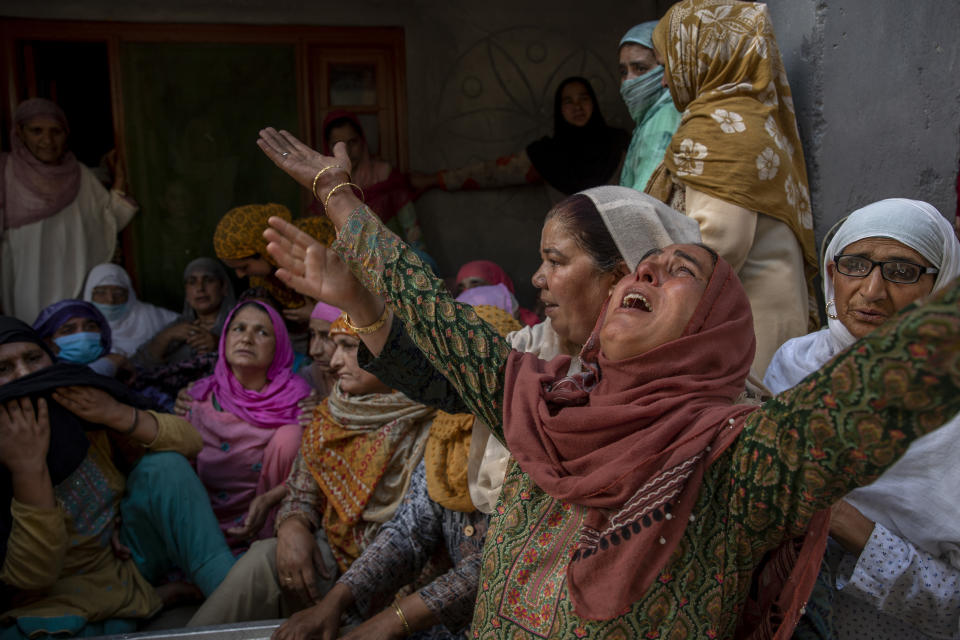 Relatives wail during the funeral of Waseem Ahmed, a policeman who was killed in a shootout, on the outskirts of Srinagar, Indian controlled Kashmir, Sunday, June 13, 2021. Two civilians and two police officials were killed in an armed clash in Indian-controlled Kashmir on Saturday, police said, triggering anti-India protests who accused the police of targeting the civilians. (AP Photo/ Dar Yasin)