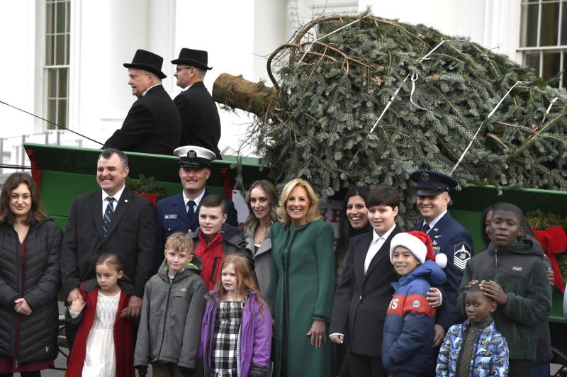 First lady Jill Biden poses with the children of military families Monday as they view the arrival of the official 2023 White House Christmas Tree, at the White House in Washington, D.C. The Fraser fir from Fleetwood, North Carolina helps kick off Holiday festivities in the Nation's Capital. Photo by Mike Theiler/UPI