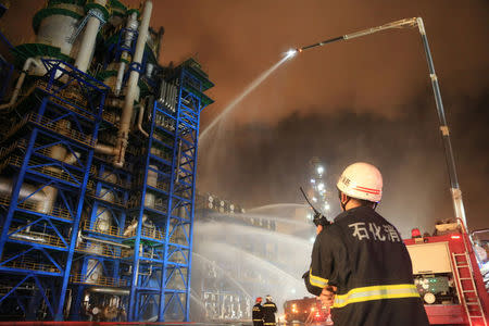 Firefighters spray water onto a fire at state oil major PetroChina's plant in Dalian, Liaoning province, China August 17, 2017. Picture taken August 17, 2017. REUTERS/Stringer ATTENTION EDITORS - THIS IMAGE WAS PROVIDED BY A THIRD PARTY. CHINA OUT. NO COMMERCIAL OR EDITORIAL SALES IN CHINA.