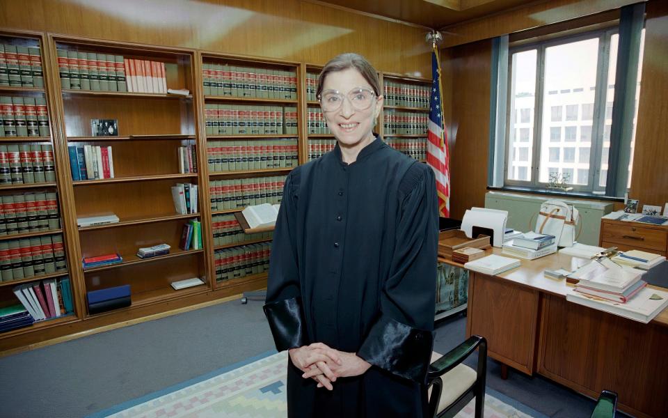 In this Aug. 3, 1993, file photo, then-Judge Ruth Bader Ginsburg poses in her robe in her office at U.S. District Court in Washington. Earlier, the Senate voted 96-3 to confirm Bader as the 107th justice and the second woman to serve on the Supreme Court - Doug Mills/AP