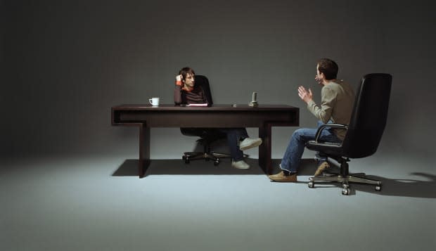 Two men having discussion at desk