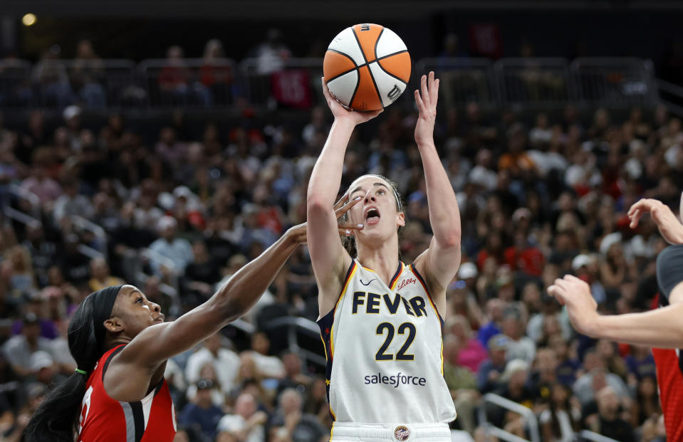 Indiana Fever guard Caitlin Clark (22) is fouled by Las Vegas Aces guard Jackie Young (0) during the second half of an WNBA basketball game Tuesday, July 2, 2024, in Las Vegas. (Steve Marcus/Las Vegas Sun via AP)