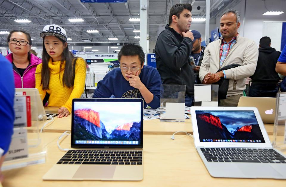 SAN DIEGO, CA - NOVEMBER 26:  Shoppers look over computer items at a Best Buy on November 26, 2015 in San Diego, California.  Although Black Friday sales are expected to be strong, many shoppers are opting to buy online or retailers are offering year round sales and other incentives that are expected to ease crowds. (Photo by Sandy Huffaker/Getty Images)