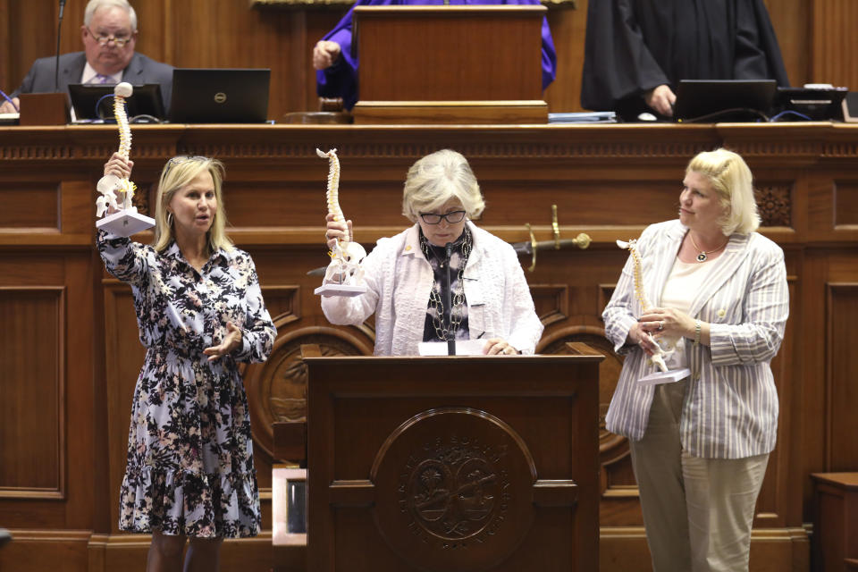 FILE - South Carolina Sens. Sandy Senn, R-Charleston, left, Katrina Shealy, R-Lexington, center, and Penry Gustafson, R-Camden, right, show off model spines they were sent by groups who want to outlaw almost all abortions. North Dakota adopted a new abortion ban, while South Carolina and Nebraska lawmakers failed to and Washington and Minnesota protected abortion access.(AP Photo / Jeffrey Collins, File)