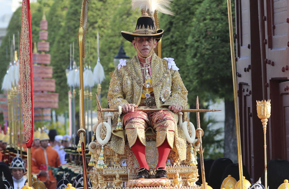 Thailand's King Maha Vajiralongkorn is carried on a palanquin through the streets outside the Grand Palace for the public to pay homage to him on the second day of his coronation ceremony in Bangkok, Sunday, May 5, 2019. Vajiralongkorn was officially crowned Saturday amid the splendor of the country's Grand Palace, taking the central role in an elaborate centuries-old royal ceremony that was last held almost seven decades ago. (AP Photo/Sakchai Lalit)