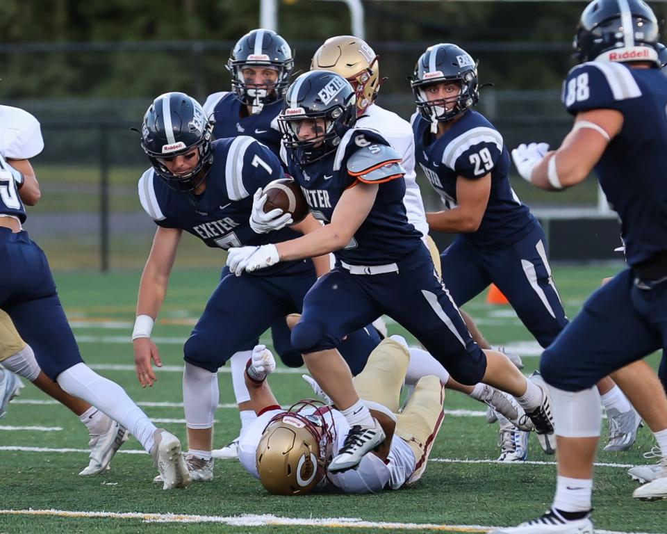 Exeter's Evan Delorie runs back the opening kickoff for a touchdown in the season-opening game against Portsmouth/Oyster River.