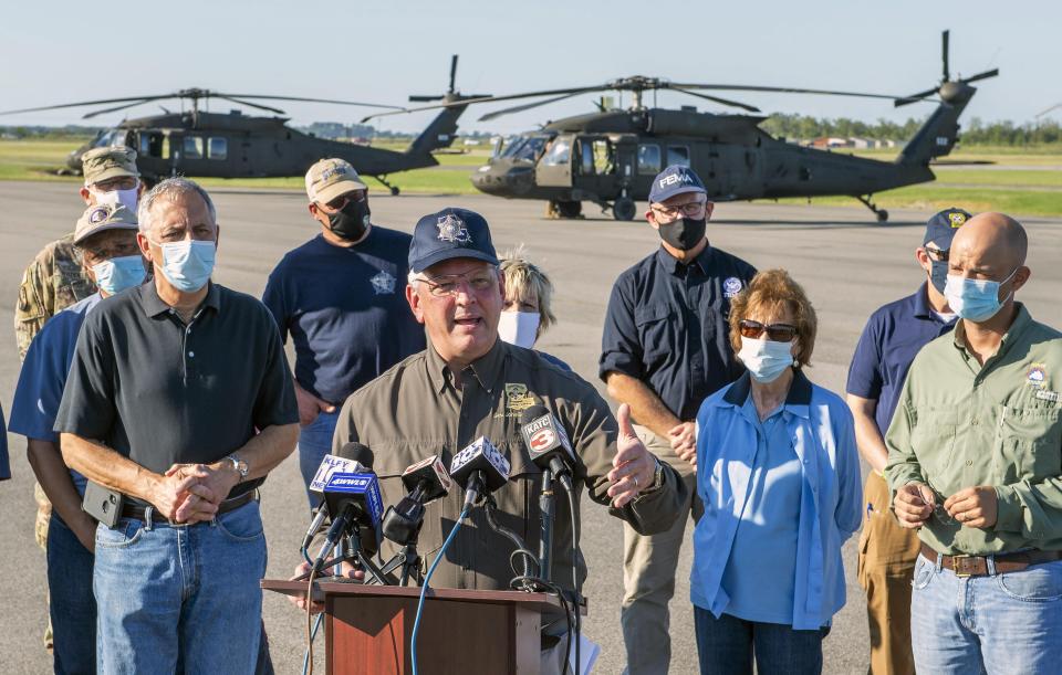 Louisiana Gov. John Bel Edwards talks about the devastation from Hurricane Delta after flying over the stricken areas in southwest Louisiana during a press conference at the airport Saturday Oct. 10, 2020, in Jennings, La. (Bill Feig/The Advocate via AP, Pool)