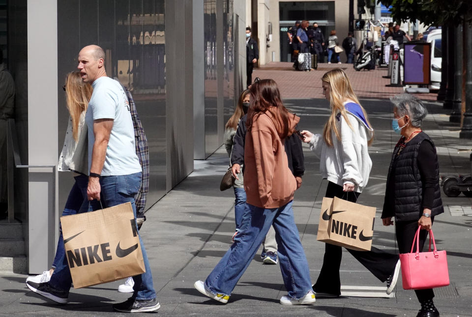 SAN FRANCISCO, CALIFORNIA - MARCH 31: Shoppers carry shopping while walking through the Union Square shopping district on March 31, 2022 in San Francisco, California. According to a report by the Commerce Department, inflation is taking its toll on the economy with consumer spending inching up a weak 0.2 percent in February compared with a 2.7 percent jump in January. (Photo by Justin Sullivan/Getty Images)