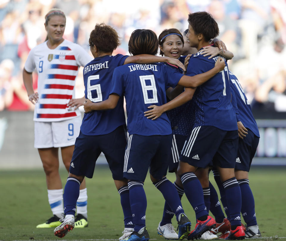 U.S. midfielder Lindsey Horan (9) watches as Japan players celebrate a goal by forward Mina Tanaka, right, during the first half of a Tournament of Nations soccer match in Kansas City, Kan., Thursday, July 26, 2018. (AP Photo/Colin E. Braley)