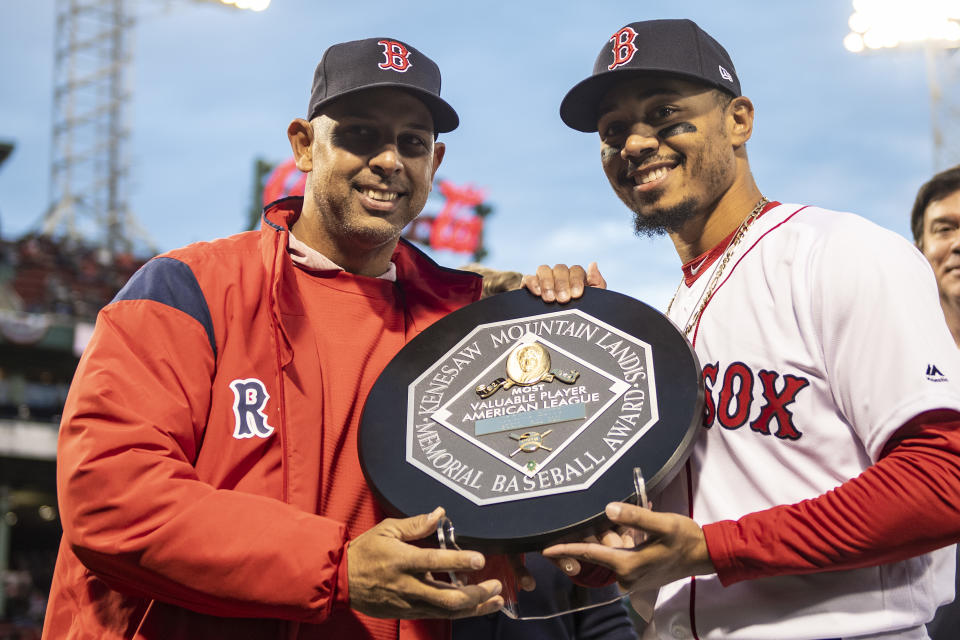 Mookie Betts, right, receives his 2018 MVP plaque, which is inscribed as the Kenesaw Mountain Landis Memorial Baseball Award. (Photo by Billie Weiss/Boston Red Sox/Getty Images)