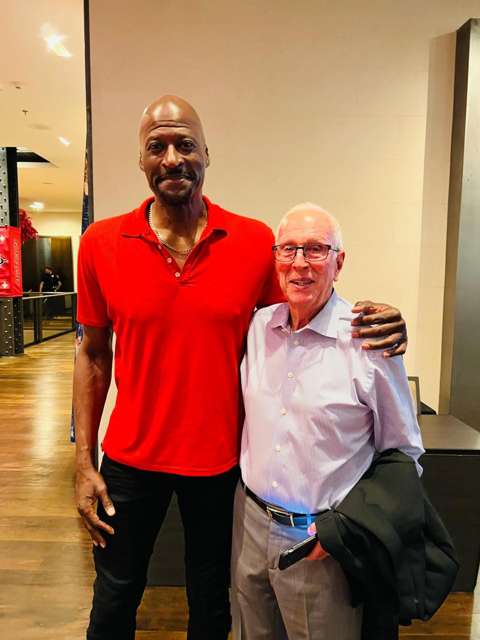 Thunder broadcaster Michael Cage, left, poses for a photo with former San Diego State head coach Steve Fisher in Houston.