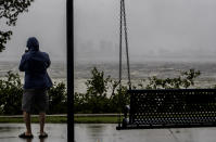 One sightseer witnesses the receding waters of Tampa Bay because of low tide and tremendous winds from Hurricane Ian with downtown in the distance in Tampa, Fla., Wednesday, Sept. 28, 2022. (Willie J. Allen Jr./Orlando Sentinel via AP)