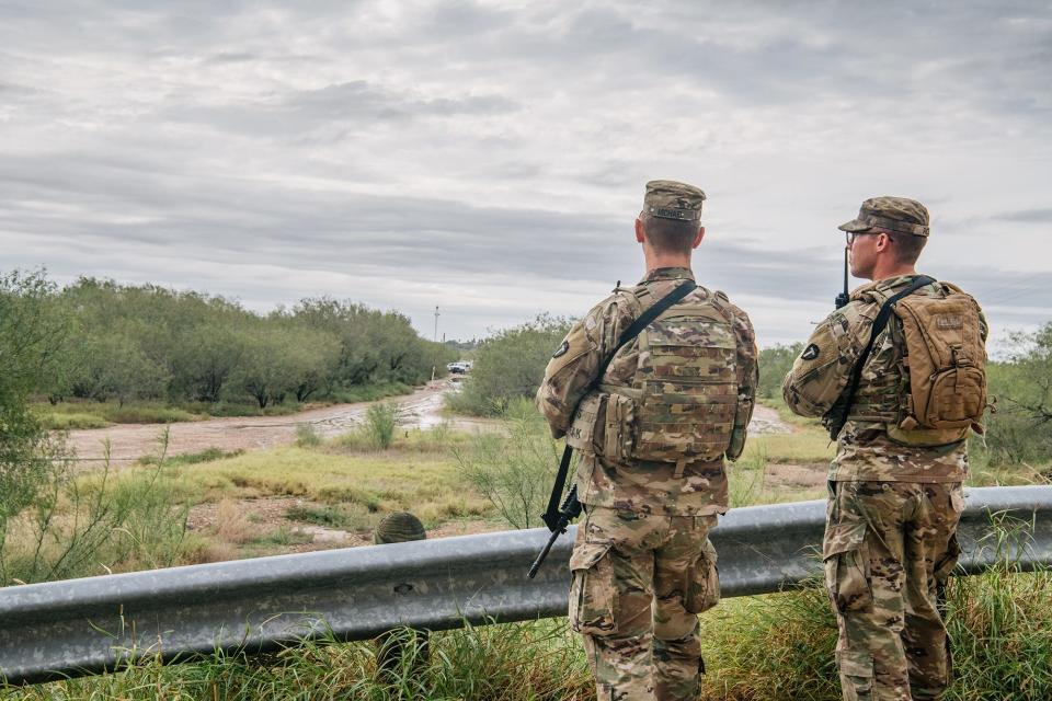 National Guard members patrol near an unfinished section of border wall on Nov. 18, 2021, in La Joya, Texas. More than 10,000 Guard members have been deployed to the border to assist in border enforcement.