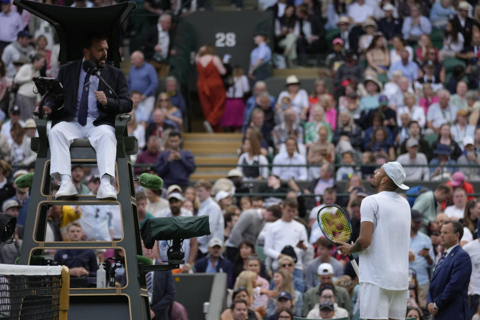 Australia's Nick Kyrgios talks to the umpire during a third round men's singles match against Greece's Stefanos Tsitsipas on day six of the Wimbledon tennis championships in London, Saturday, July 2, 2022. (AP Photo/Kirsty Wigglesworth)