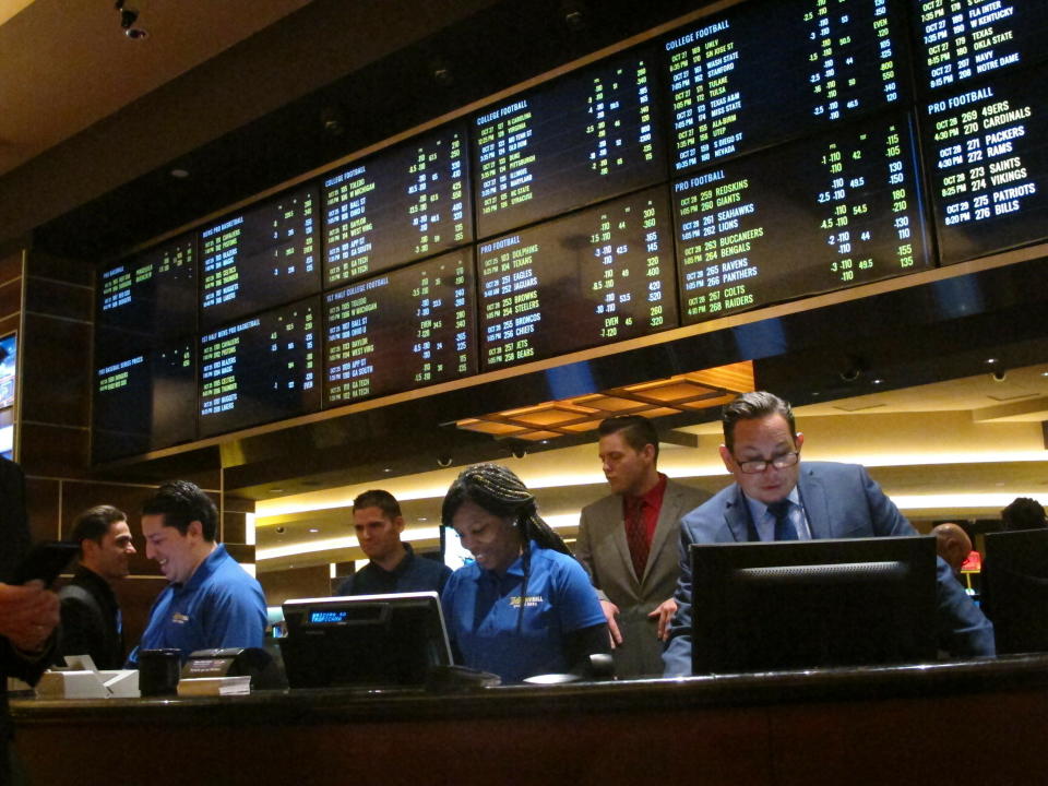 This Oct. 25, 2018 photo shows employees at the new sports book at the Tropicana casino in Atlantic City N.J., preparing to take bets moments before it opened. NBA and MLB executives staunchly believe their leagues deserve a cut of sports betting revenue. But their problem has been convincing anyone else in the sports betting world. (AP Photo/Wayne Parry, File)