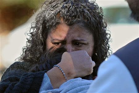 A woman holds her son after picking him up at following a school shooting in Sparks, Nevada, October 21, 2013. REUTERS/Andy Barron/Reno Gazette-Journal