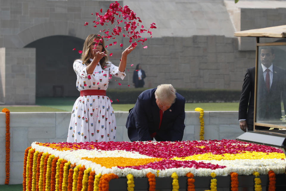 U.S. President Donald Trump and first lady Melania Trump offer their respects at Raj Ghat, the memorial for Mahatma Gandhi, in New Delhi, India, Tuesday, Feb. 25, 2020. (AP Photo/Alex Brandon)