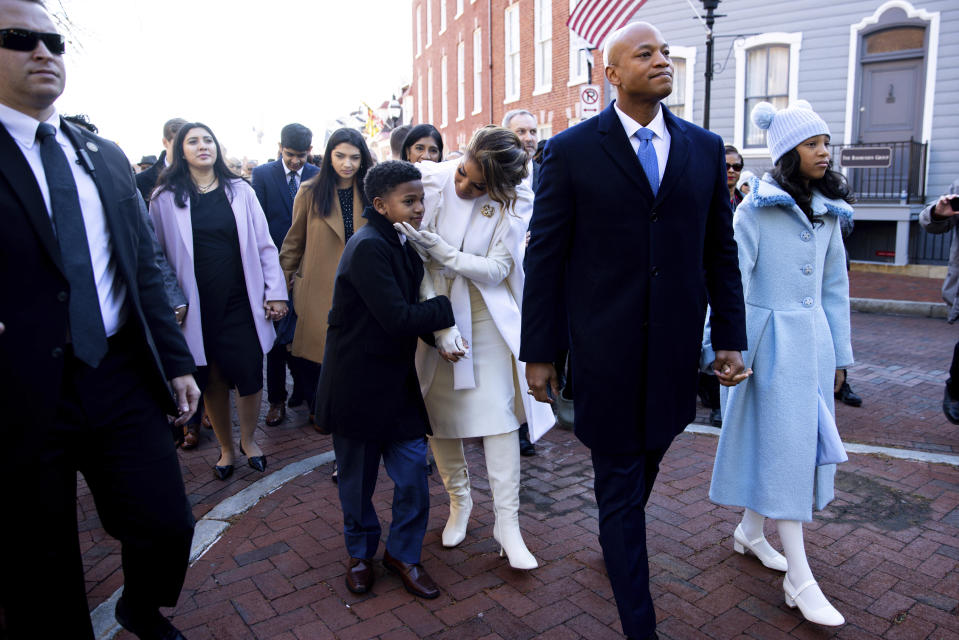 Dawn Flythe Moore hugs son James as Maryland Gov.-elect Wes Moore leads a march to the Governor's Mansion prior to his inauguration in Annapolis, Md., Wednesday, Jan. 18, 2023. (AP Photo/Julia Nikhinson)