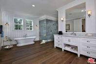 <p>It also connects to a master bathroom with a large soaker tub and a double-vanity sink. (Realtor.com) </p>