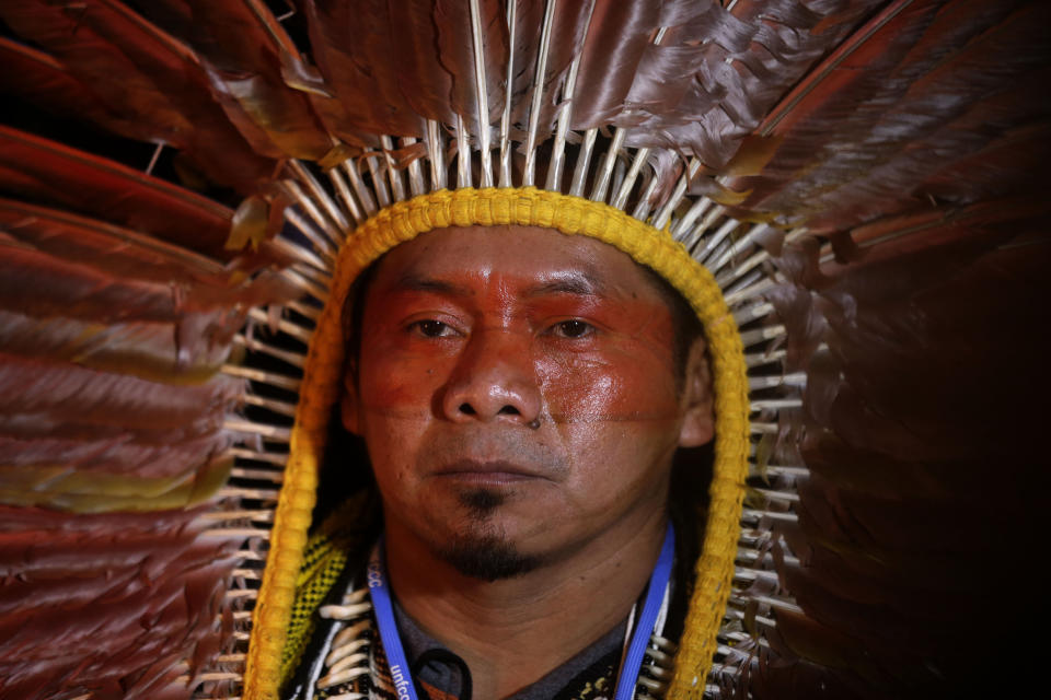 A demonstrator gathers before marching in Madrid on the sidelines of UN climate talks, on Friday Dec. 6, 2019. (AP Photo/Paul White)