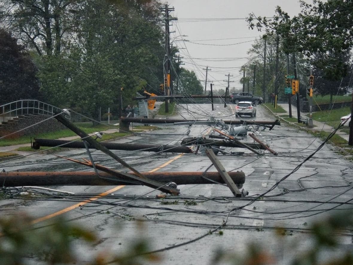 Joshawa Tyler LaVoie captured this striking image of downed power lines and poles on Woodlawn Road in Dartmouth, N.S., on Saturday. (Submitted by Joshawa Tyler LaVoie - image credit)