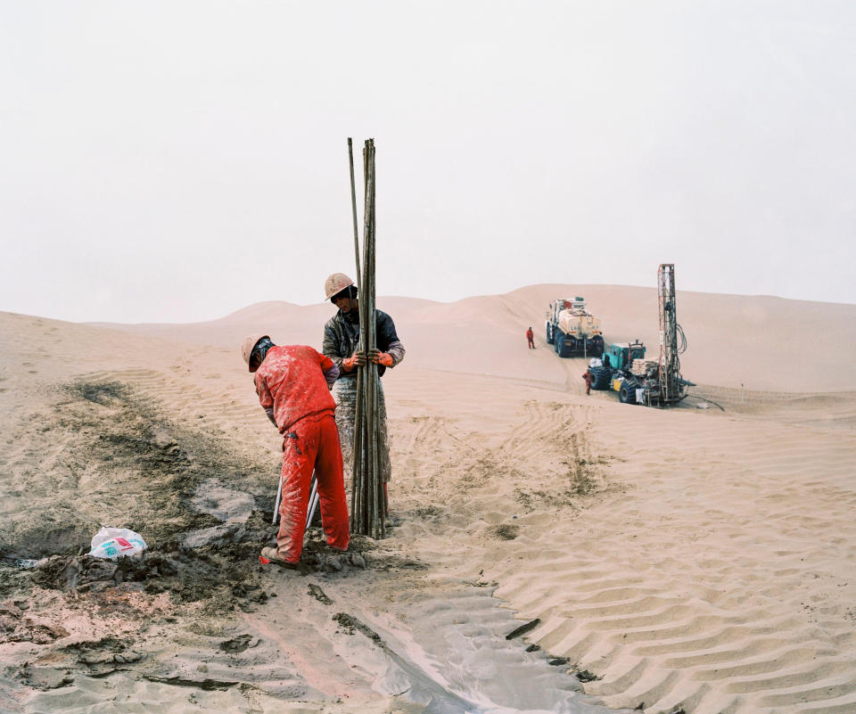 An oil exploration team from a Chinese state-owned company operates in the Taklamakan Desert, in China's westermost province of Xinjiang, in December 2016.