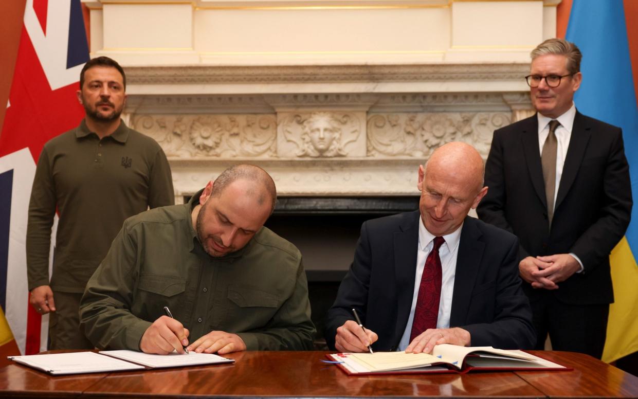 John Healey signs an agreement with his Ukrainian counterpart Rustem Umerov watched by Keir Starmer and Volodomyr Zelensky in No 10 last month