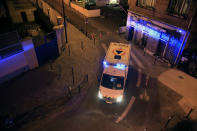 In this photo taken Thursday, March 26, 2020 an ambulance of the Civil Protection service is parked in a street to evacuate man suspected of having the coronavirus infection in Paris. (AP Photo/Michel Euler)