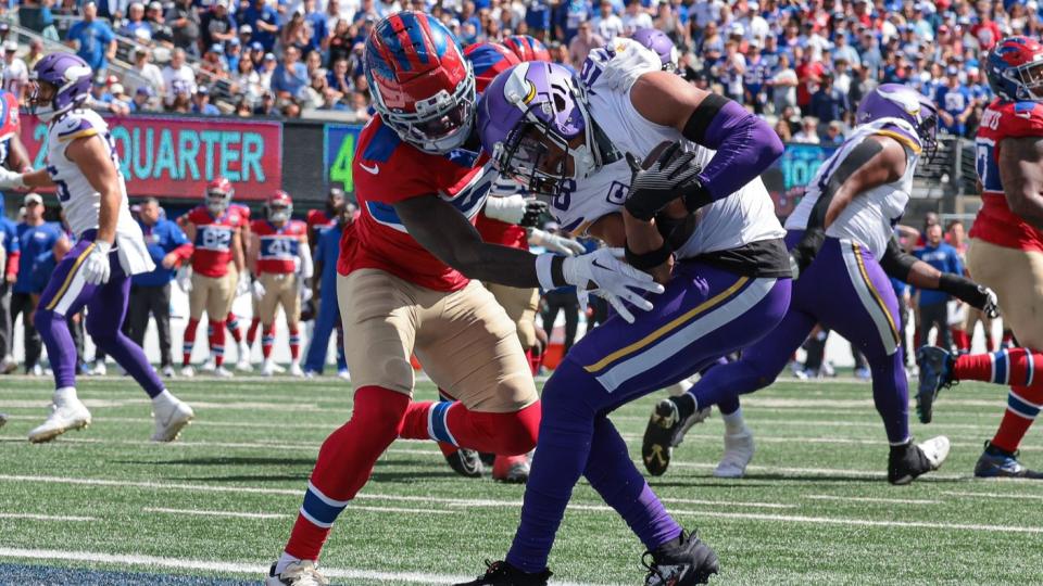 Sep 8, 2024; East Rutherford, New Jersey, USA; Minnesota Vikings wide receiver Justin Jefferson (18) catches a touchdown pass as New York Giants cornerback Deonte Banks (3) defends during the first half at MetLife Stadium. 