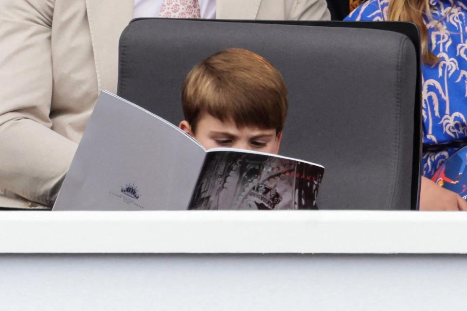 Louis was seen reading the programme (POOL/AFP via Getty Images)