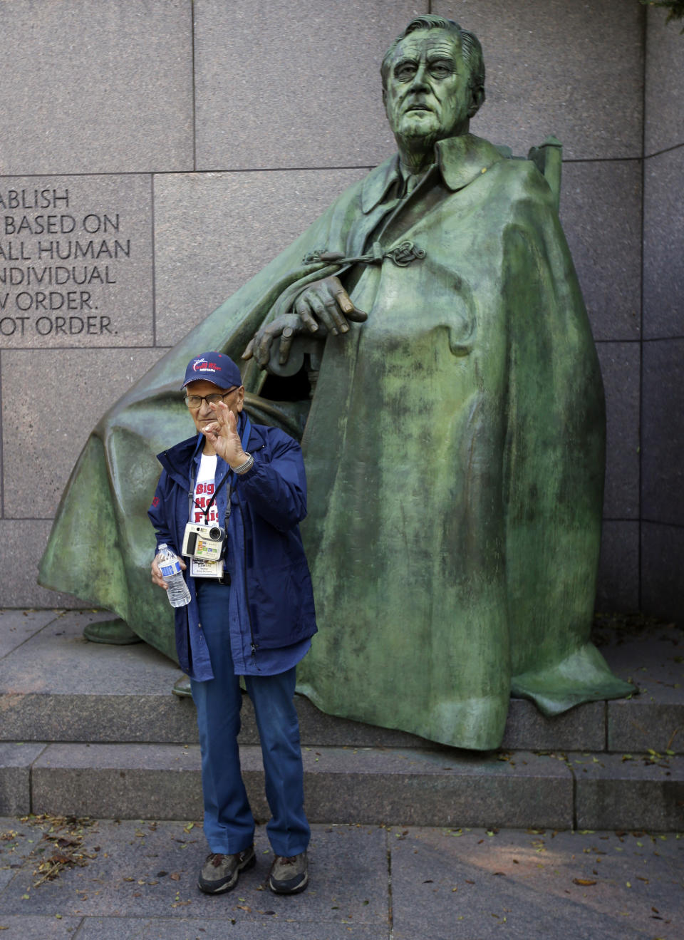 Edward Swetish of Helena, Mont., a WWII veteran, poses for a photograph in front of a statue of President Roosevelt at the Franklin Delano Roosevelt Memorial, Monday, Oct. 14, 2013, in Washington. (AP Photo/Alex Brandon)