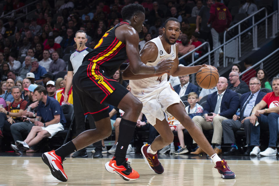 Cleveland Cavaliers forward Evan Mobley drives against Atlanta Hawks center Clint Capela during the second half of an NBA basketball game Tuesday, March 28, 2023, in Atlanta. (AP Photo/Hakim Wright Sr.)