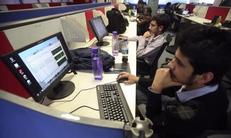 Employees of Snapdeal.com, an Indian online discount shopping website, work inside their company office in New Delhi March 1, 2012. REUTERS/Parivartan Sharma