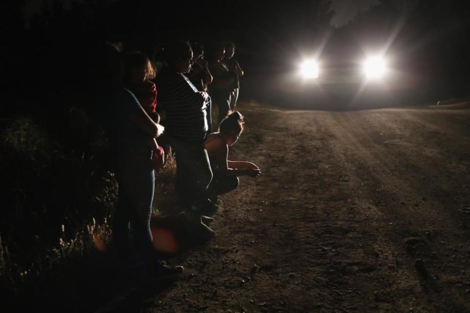 Central American asylum seekers wait for transport while being detained near the US-Mexico border