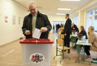 Latvian President Egils Levits casts his ballot at a polling station during general elections in Riga, Latvia, Saturday, Oct. 1, 2022. Polling stations opened Saturday in Latvia for a general election influenced by neighboring Russia’s attack on Ukraine, disintegration among the Baltic country’s sizable ethnic-Russian minority and the economy, particularly high energy prices. (AP Photo/Roman Koksarov)