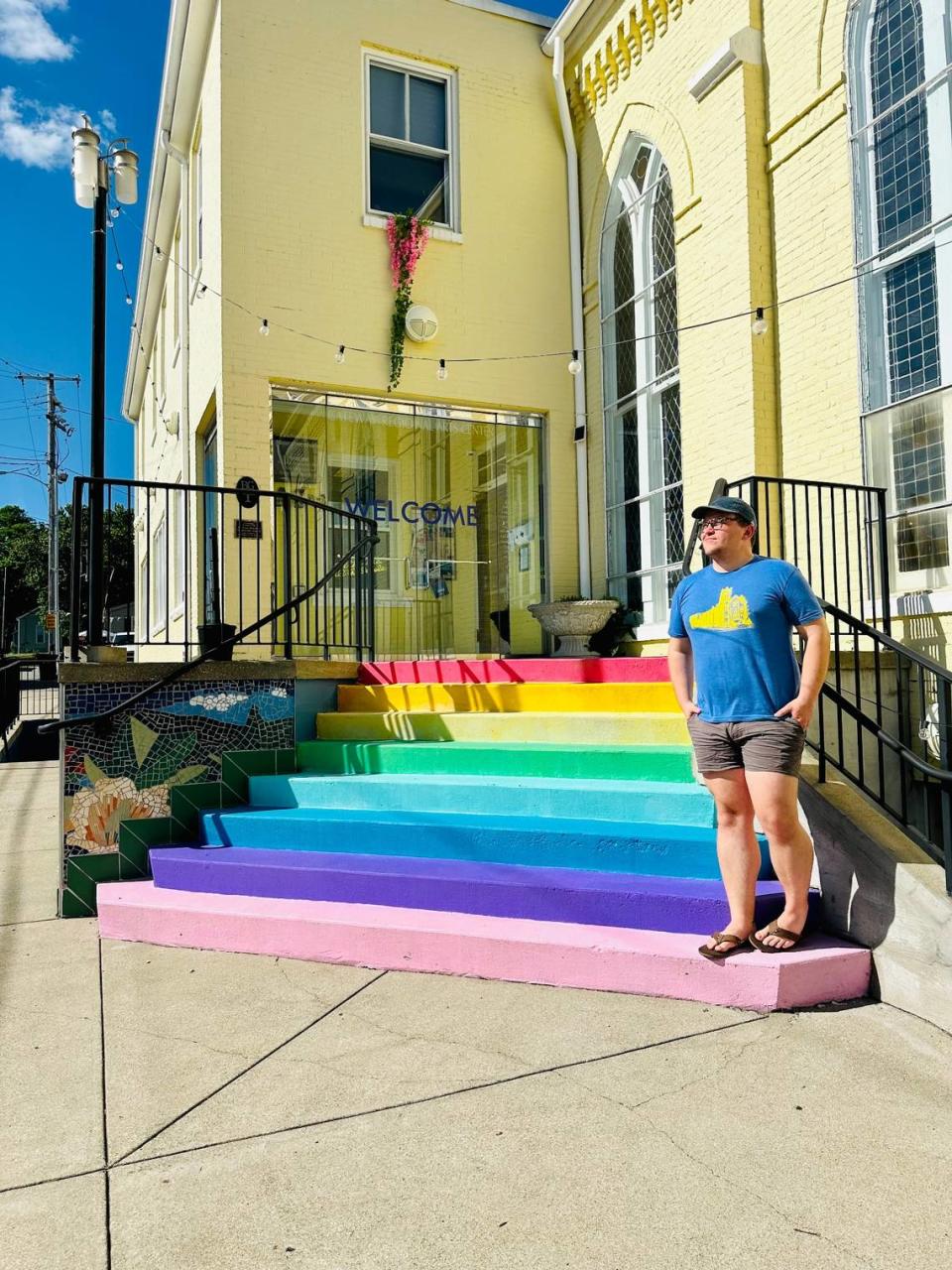 Jordan Campbell, the executive director of the Gateway Regional Arts Center, poses on the building’s front steps.