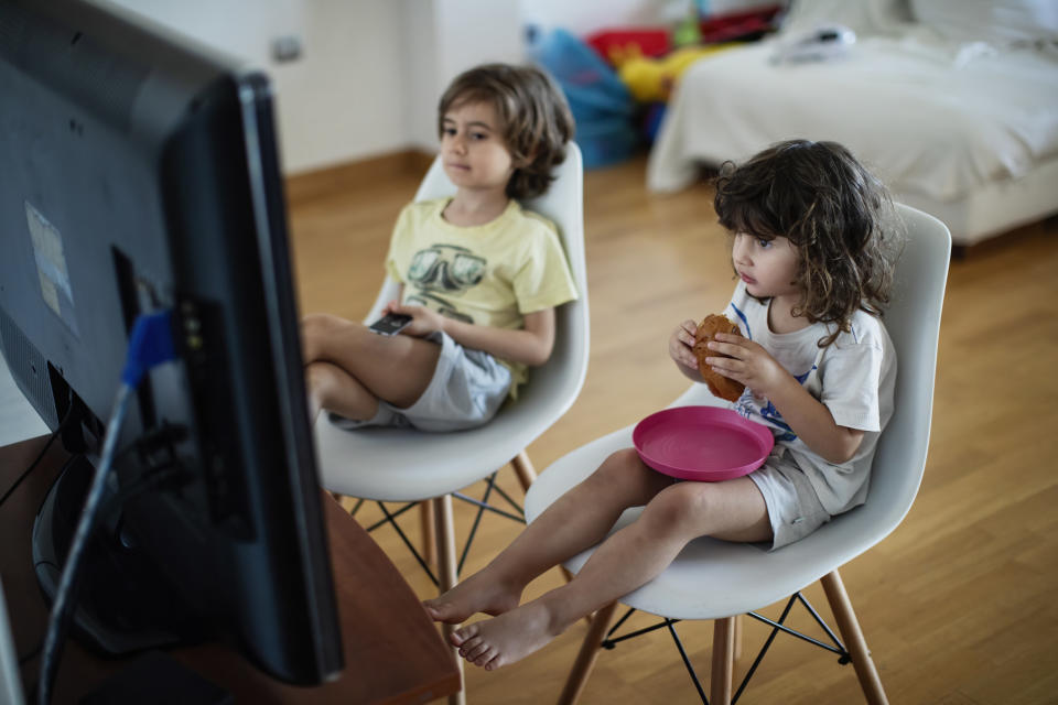 Toddlers sitting in front of the TV