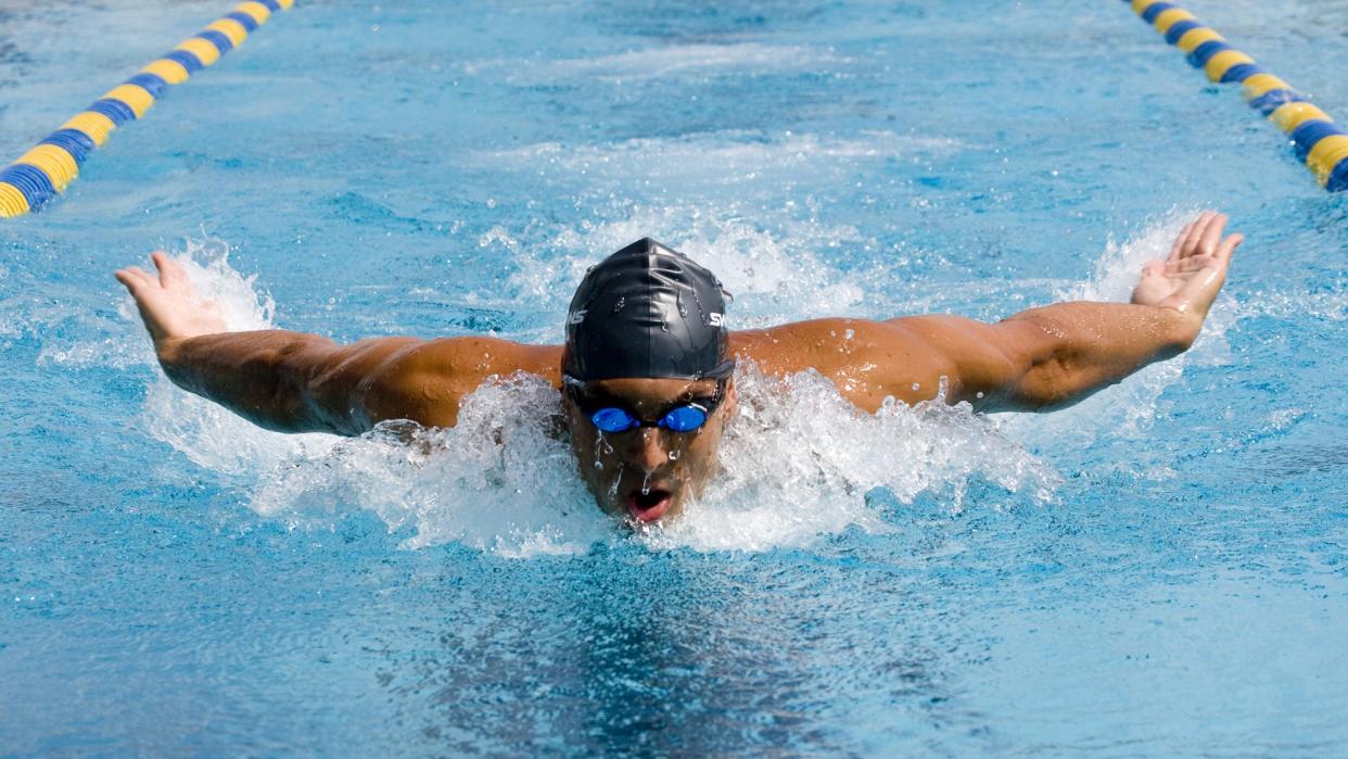  A photo of a man doing butterfly stroke. 