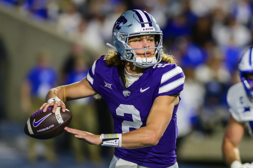 Kansas State quarterback Avery Johnson (2) runs out of the pocket and looks to pass during the first half of an NCAA college football game against BYU, Saturday, Sept. 21, 2024, in Provo, Utah. (AP Photo/Tyler Tate)