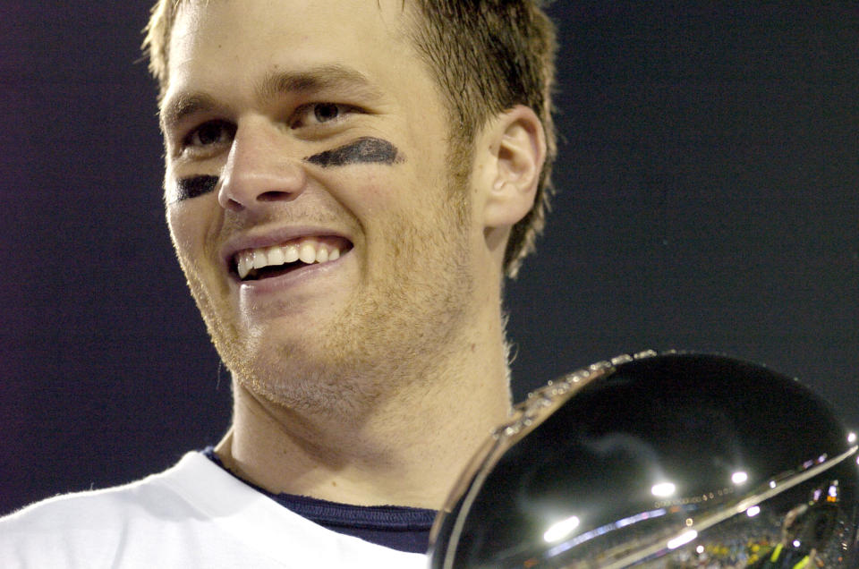 Tom Brady holds the Vince Lombardi Trophy as he stands on the podium after The New England Patriots defeated The Philadelphia Eagles in Super Bowl XXXIX at Alltel Staduim in Jacksonville, Florida.  (Photo by Al Messerschmidt/Getty Images)