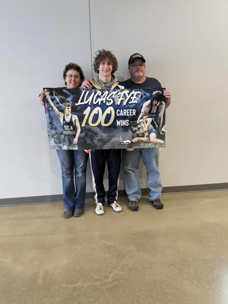 Bald Eagle Area’s Lucas Fye celebrates his 100th career win with his parents, Deanne and Shawn. Fye pinned Butler’s Sullivan Stutz in 1:34 of their first round match of the Mid Winter Mayhem on Friday.