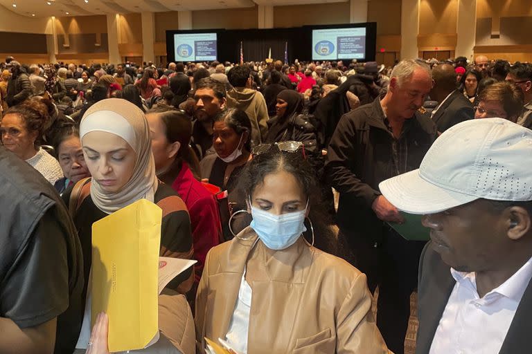 Hundreds of people become U.S. citizens during a naturalization ceremony at a convention center in Saint Paul, Minn., on March 9, 2023. The U.S. citizenship test is being updated and some immigrants and advocates worry the changes will hurt test-takers with lower levels of English proficiency. The test is one of the final steps toward citizenship — a months-long process that requires legal permanent residency for years before applying. (AP Photo/Trisha Ahmed)