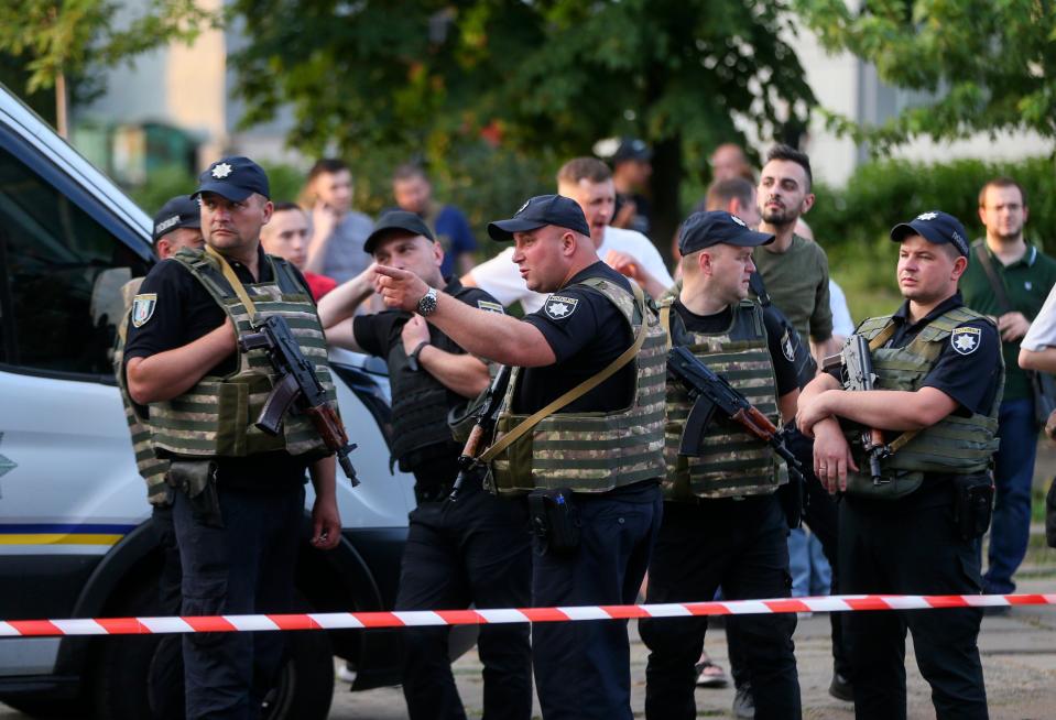 Armed Ukrainian policemen keep watch outside, after an explosion at the Shevchenkiv District Court, in Kyiv, Ukraine (EPA)