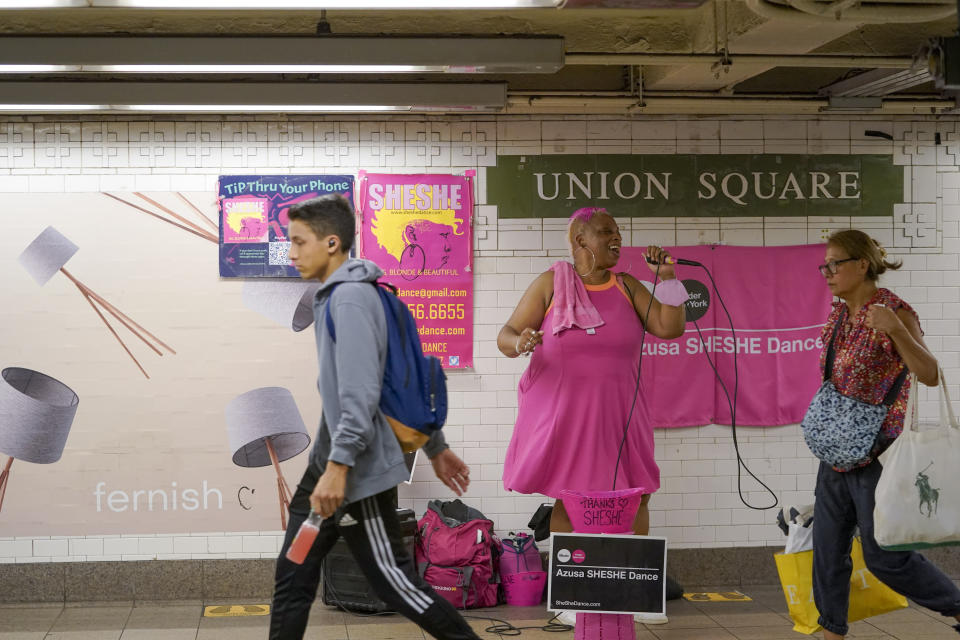 Singer AAzusa "SHESHE" Dance performs at the Union Square subway station, Tuesday, Sept. 13, 2022, in New York. It's becoming clearer that New York City's recovery from the pandemic will be drawn out and that some aspects of the city's economic ecosystem could be changed for good. More workers returned to their offices as the summer ended. But those limited numbers mean continued hardship for New Yorkers whose jobs are built around the commuting class. (AP Photo/Mary Altaffer)