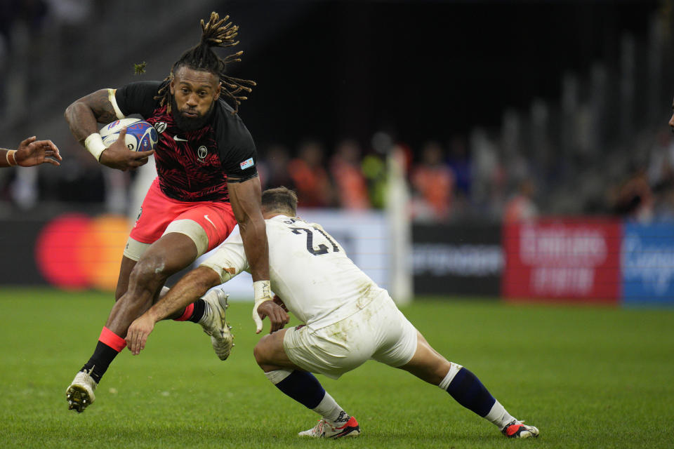 Fiji's Waisea Nayacalevu escapes England's Danny Care during the Rugby World Cup quarterfinal match between England and Fiji at the Stade de Marseille in Marseille, France, Sunday, Oct. 15, 2023. (AP Photo/Daniel Cole)