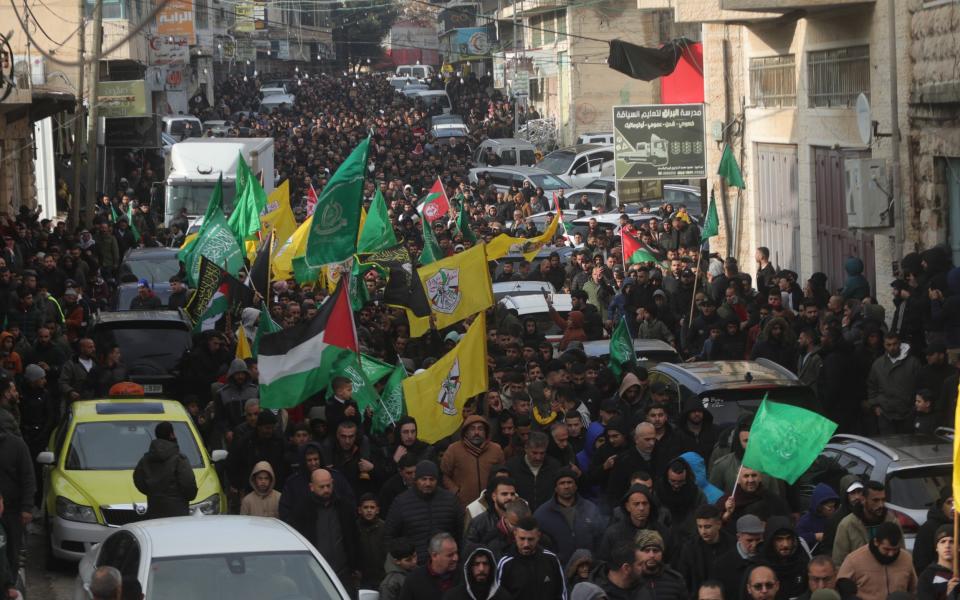 Crowds attend the funeral ceremony of Muhanned Elfasfus, 18, and Mutaz Tabish, 30, who were killed by Israeli forces during a raid at the Dura district of Hebron, West Bank