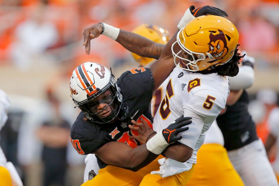 OSU defensive end Collin Oliver (30) hits Arizona State quarterback Emory Jones (5) during the Cowboys' 34-17 win on Sept. 10 in Stillwater.