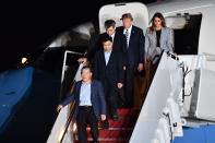 <p>President Donald Trump (2nd R) and his wife Melania Trump (R) walk down the stairs with U.S. detainees Tony Kim (2nd L), Kim Dong-chul (bottom L) and Kim Hak-song (C) upon their return after they were freed by North Korea, at Joint Base Andrews in Maryland on May 10, 2018. (Photo: Nicholas Kamm/AFP/Getty Images) </p>