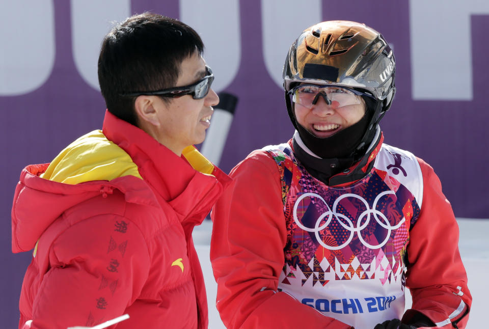 China's Xu Mengtao, right, speaks with her coach during freestyle skiing aerials training at the Rosa Khutor Extreme Park at the 2014 Winter Olympics, Monday, Feb. 10, 2014, in Krasnaya Polyana, Russia. (AP Photo/Andy Wong)