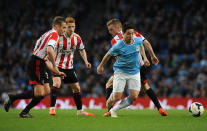 Manchester City's Samir Nasri, right, evades Sunderland's Andrea Dossena, left, Jack Colback and Sebastian Larsson during the English Premier League soccer match between Manchester City and Sunderland at The Etihad Stadium, Manchester, England, Wednesday, April 16, 2014. (AP Photo/Rui Vieira)